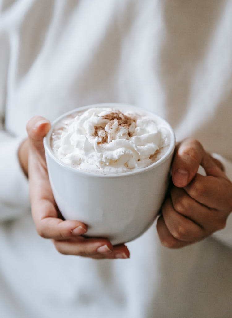 Woman With Mug Of Coffee With Whipped Cream