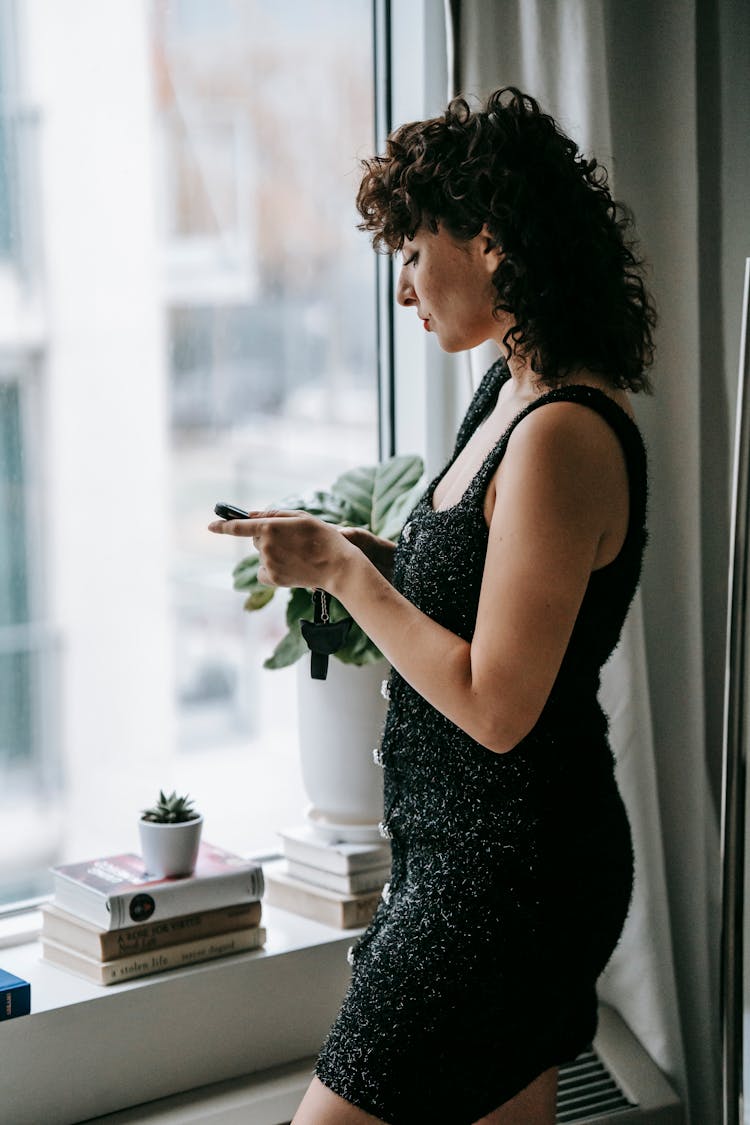 Elegant Woman Chatting On Smartphone At Home