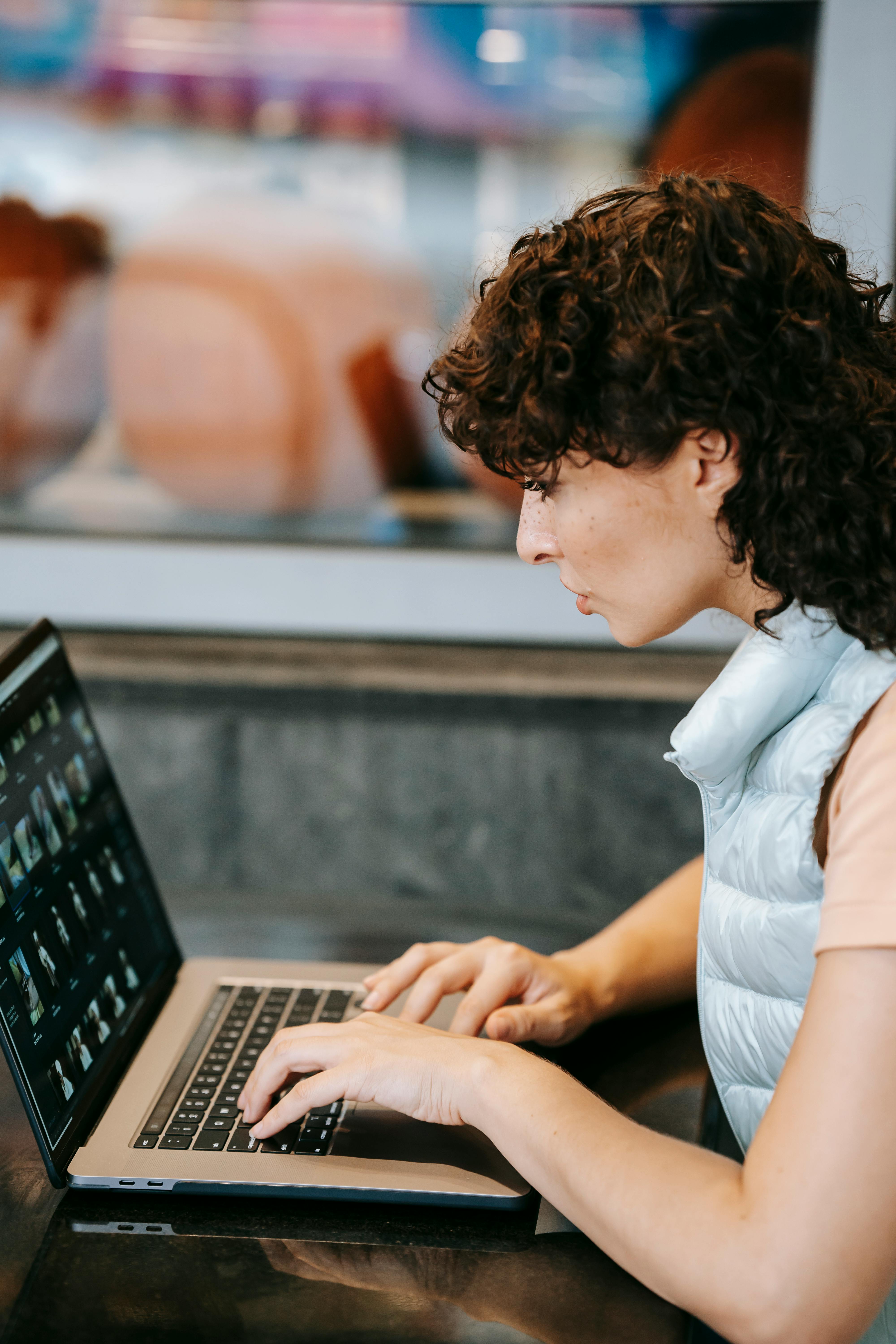 crop freelancer working on laptop in street cafeteria