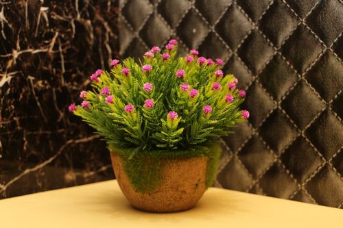 Free Artificial flowering plant pot brightens decor with realistic pink blooms and lush greenery. Stock Photo
