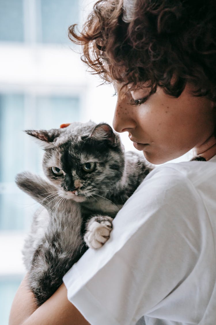 Woman Caressing Cat With Closed Eyes