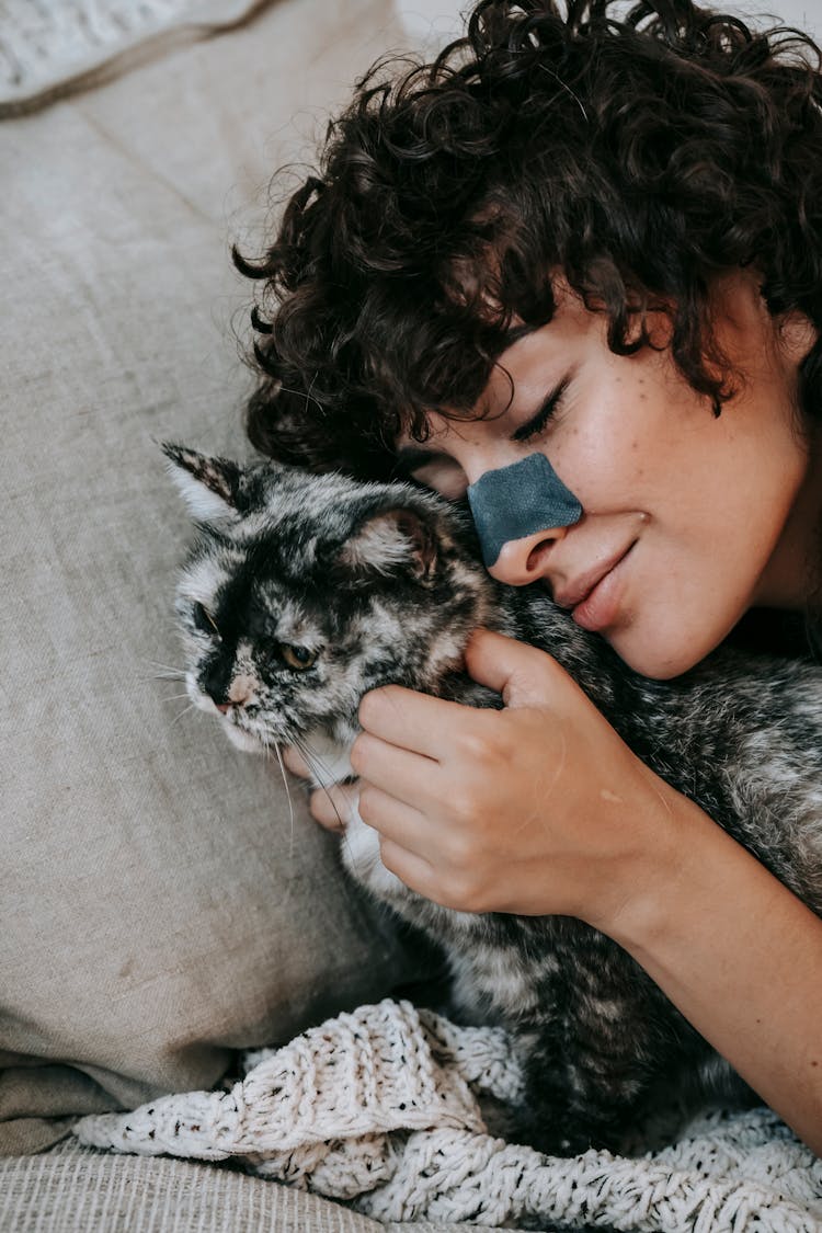 Positive Woman Petting Dappled Cat