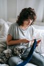 Focused woman knitting in room