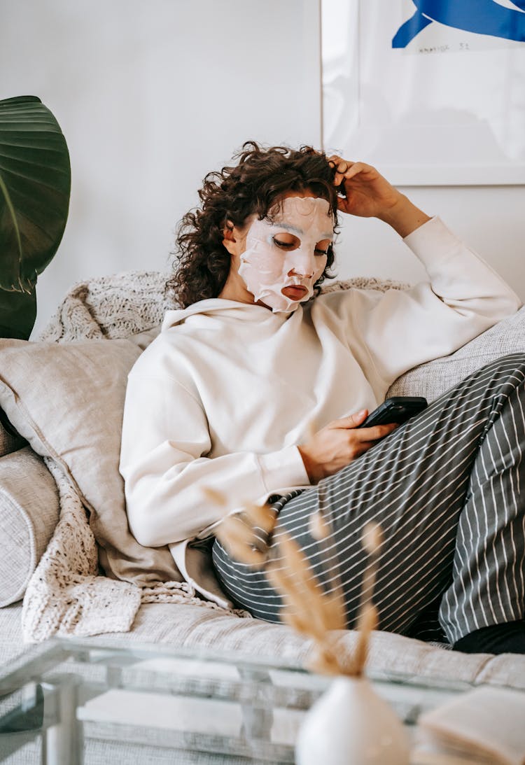 Woman With Sheet Mask Surfing Smartphone