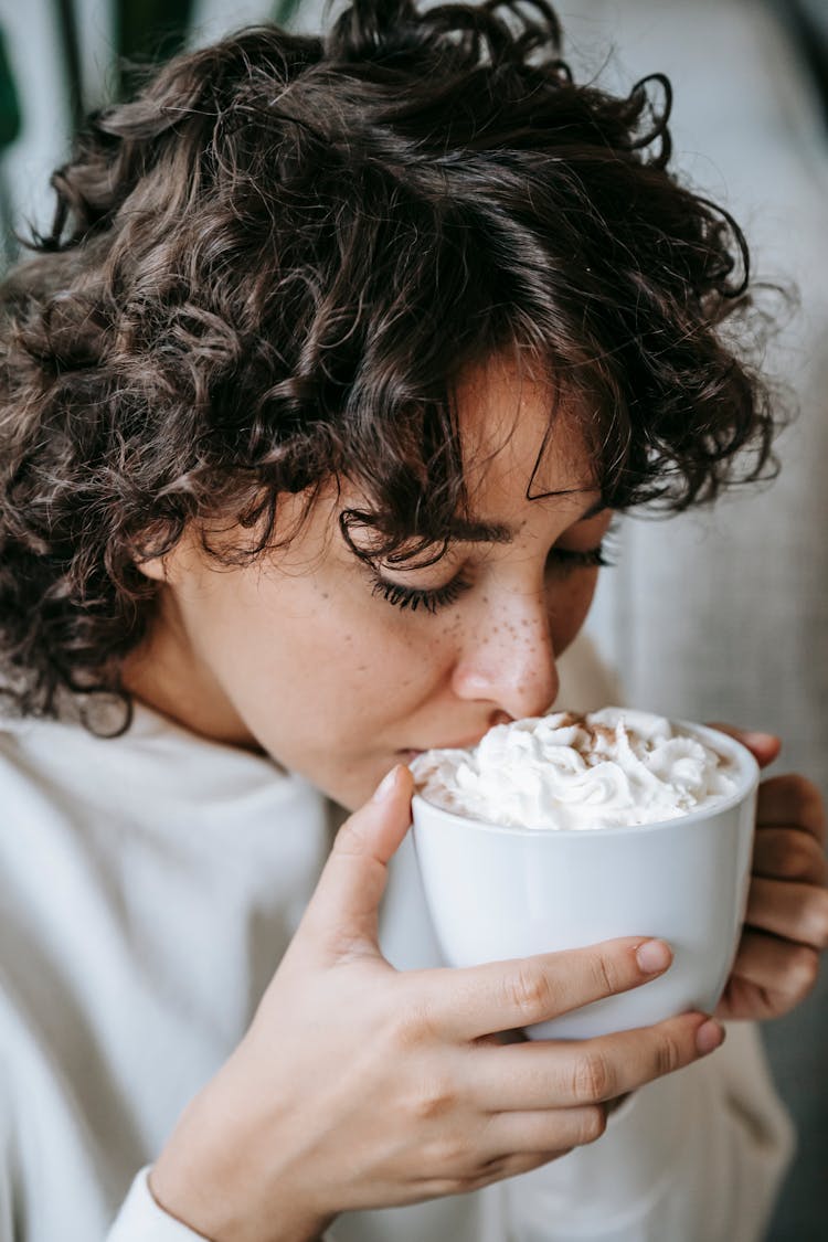 Charming Female Drinking Hot Coffee With Whipped Cream