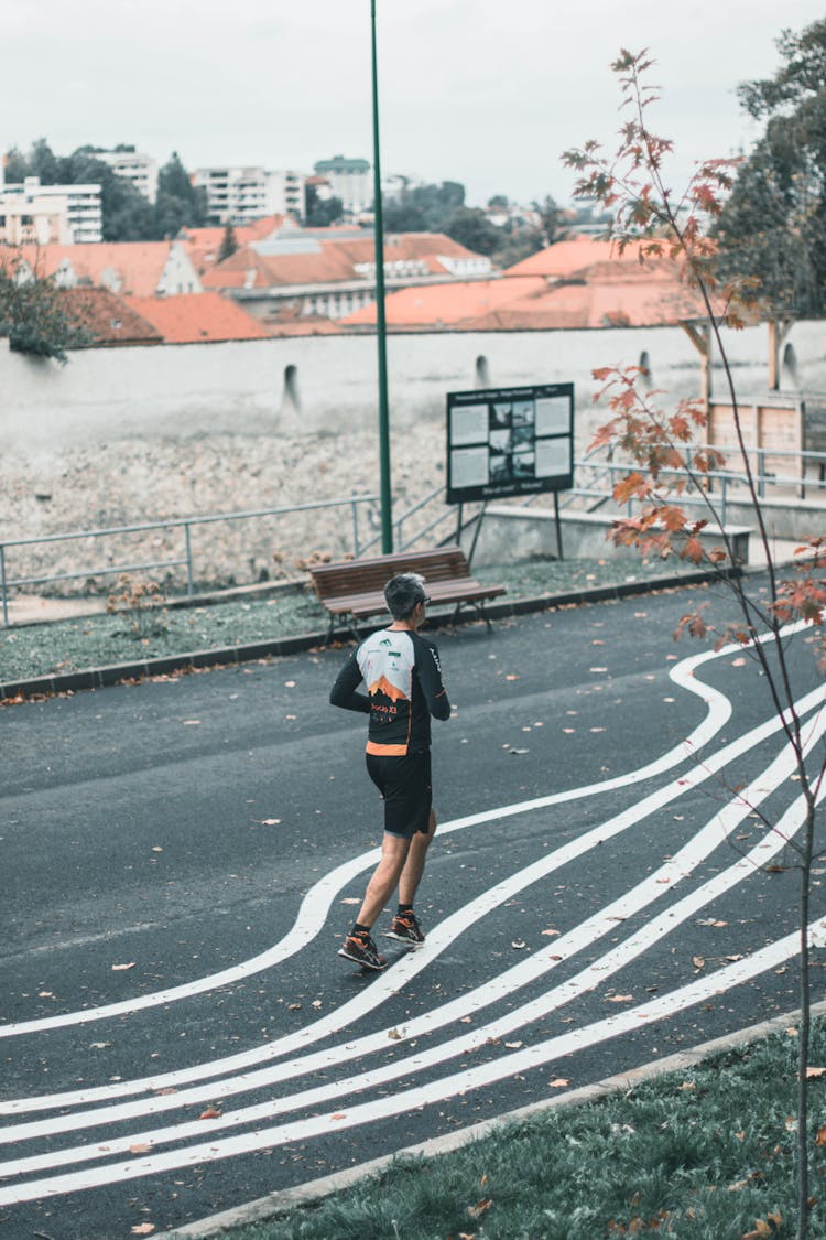 Man Running Outdoors In Autumn