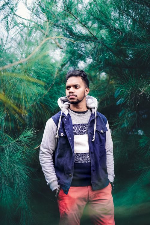 Man in Hoodie Jacket Standing Near Green Trees · Free Stock Photo