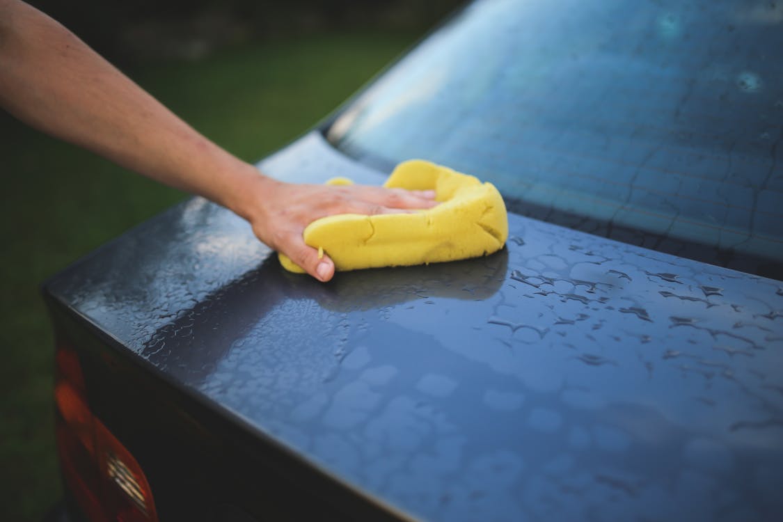 Washing a car with a sponge