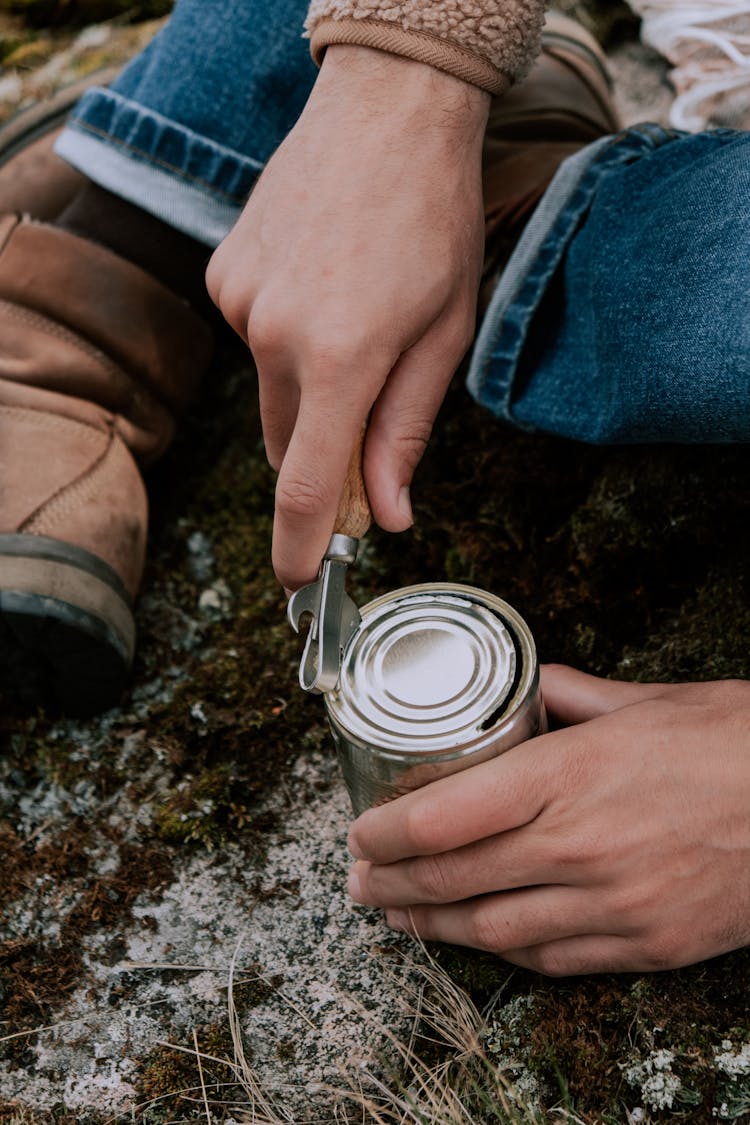 A Person Opening A Tin Can 