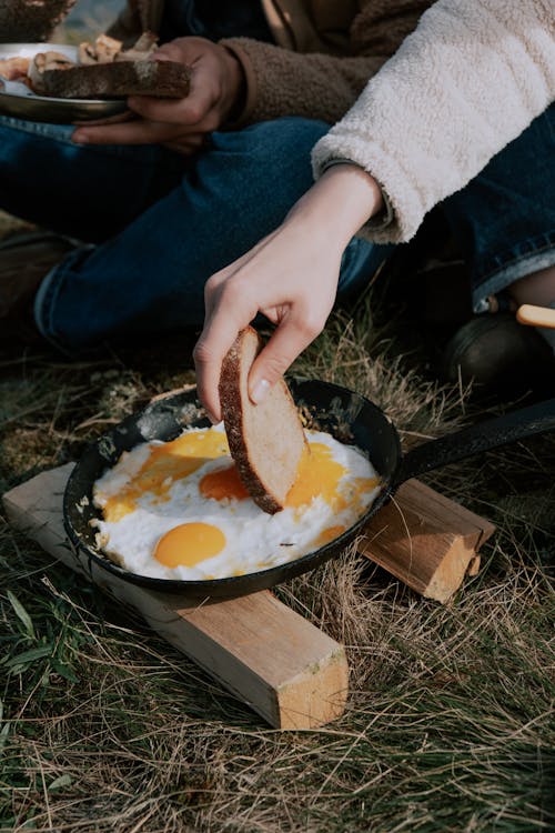 Free Person Holding a Bead with Fried Egg Stock Photo