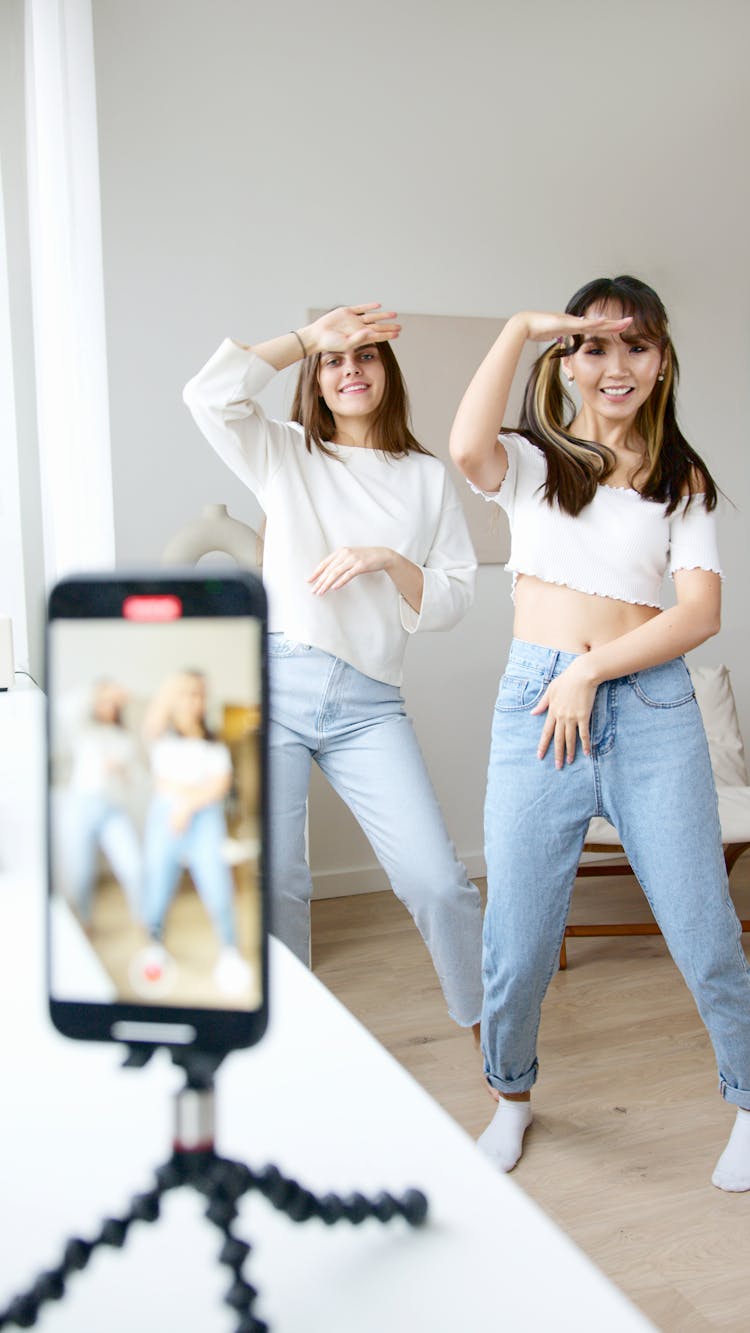 Women In White Top And Denim Jeans Dancing