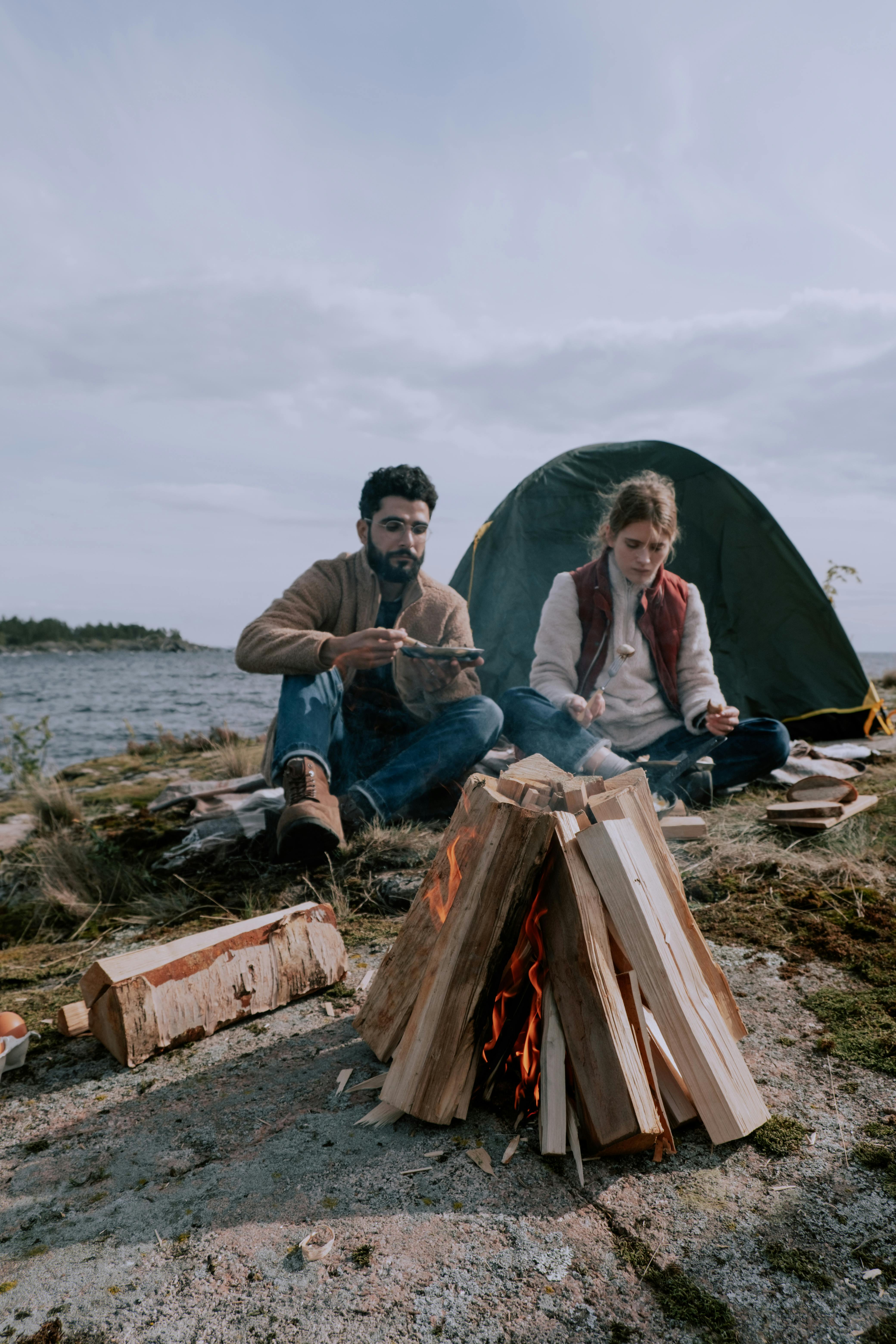 Man and Woman Camping by River in Summer