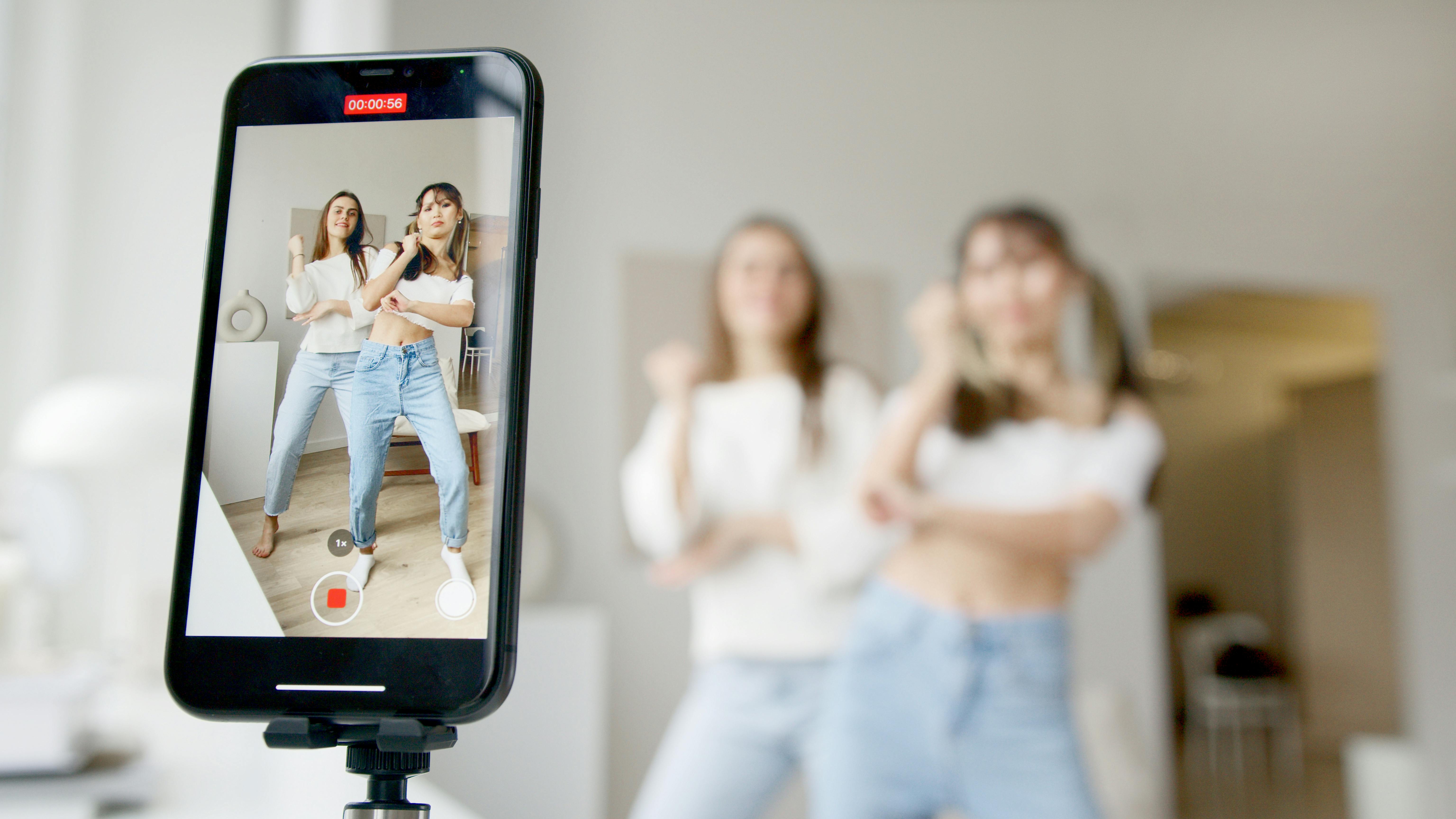 women recording using a smartphone