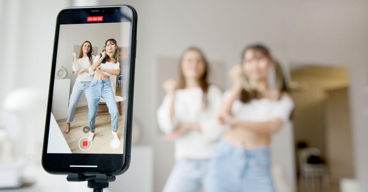 A split-screen showing a viral TikTok dance video on one side and the same song topping the Spotify Global 50 chart on the other
