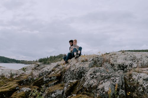 Couple Sitting on Stones with Lichen