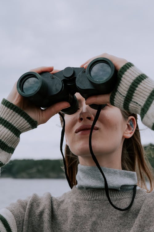 A Woman Looking Through Binoculars