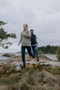 Man Chasing Woman on a Rocky Field