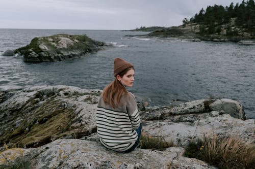 Photo of a Woman with a Beanie Looking Over Her Shoulder
