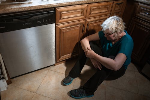 Depressed Eldery Woman Seated on the Floor