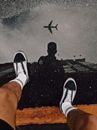 Person Wearing Black and White Adidas Sneakers