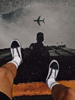 Person Wearing Black and White Adidas Sneakers
