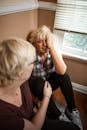 Two Women Sharing Emotional Moment while Sitting on the Floor