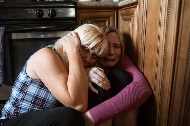 Women Sitting In A Corner Feeling Scared