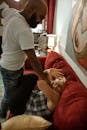 Man Hitting a Woman Lying on Sofa