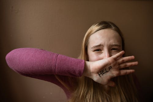 A Word Help Written on the Woman's Palm 