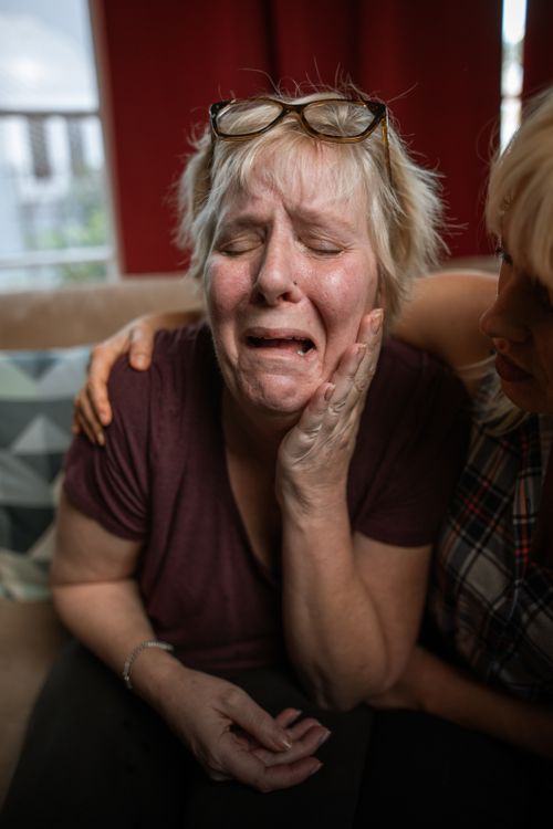 Free A touching portrait of an elderly woman in emotional distress, comforted by companionship. Stock Photo