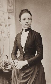 Elegant vintage portrait of a woman in Victorian attire with a classic background.. elegant, vintage, portrait