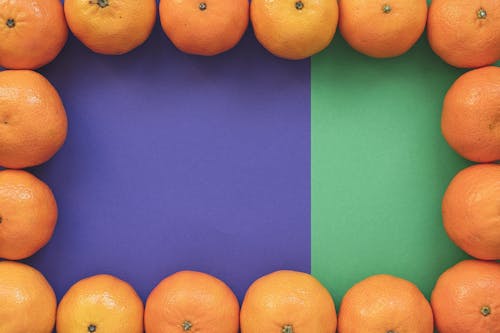 Oranges on Purple ang Green Background