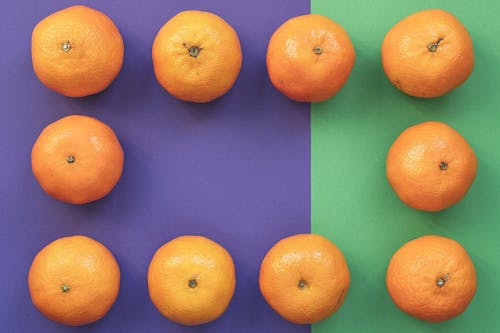 Oranges on Purple and Green Background