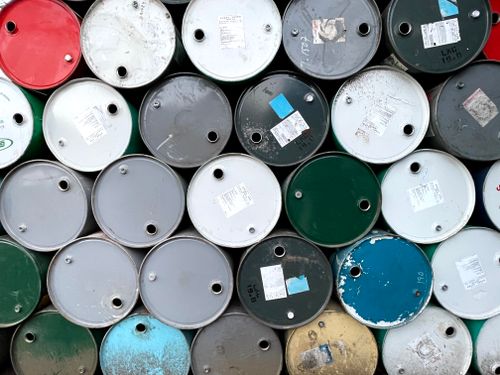 Free Close-up of colorful oil barrels stacked outdoors in Mandalay, Myanmar. Stock Photo