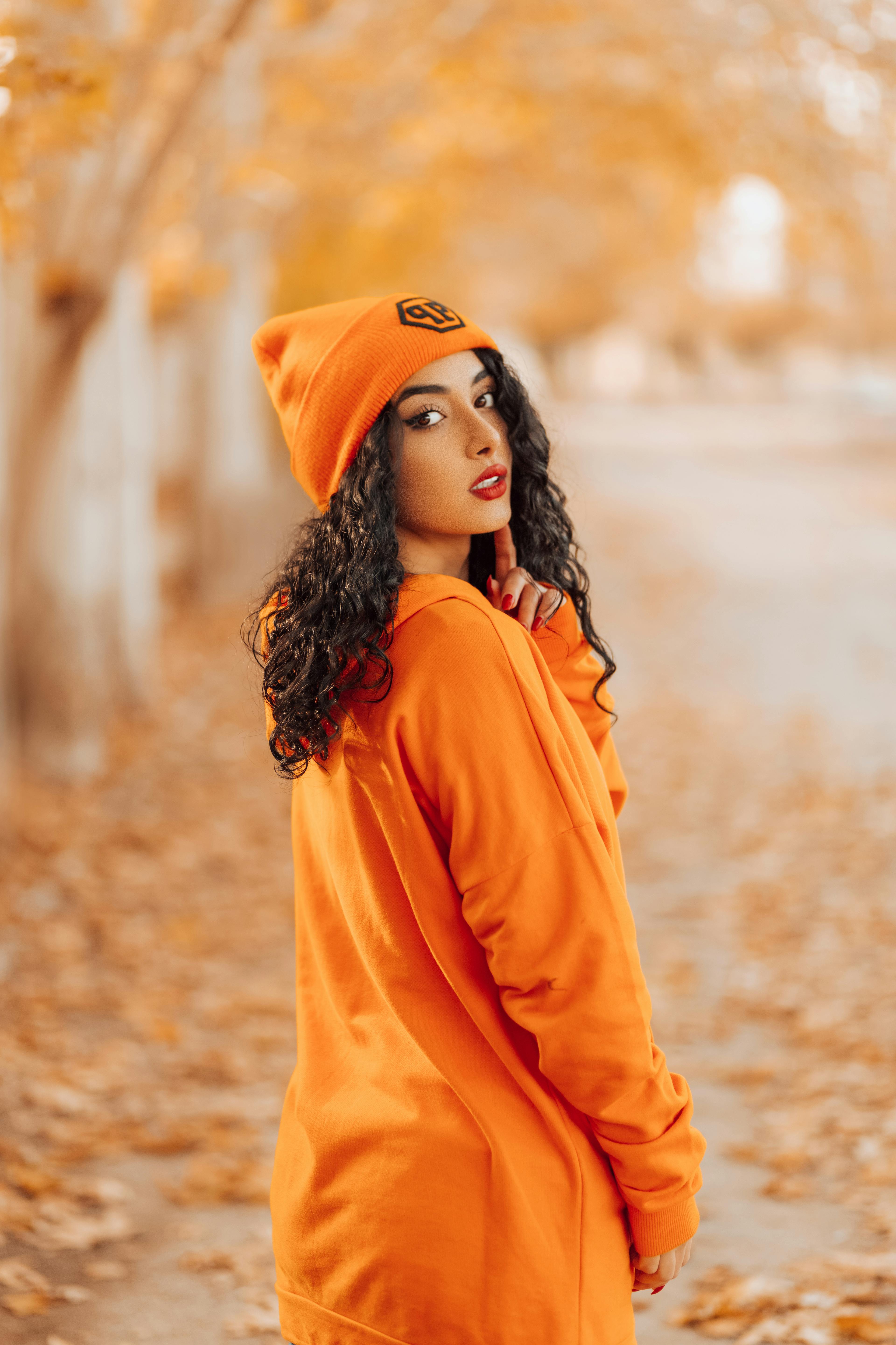 Woman Wearing Orange Pullover Hoodie and Black Capri Pants · Free Stock  Photo