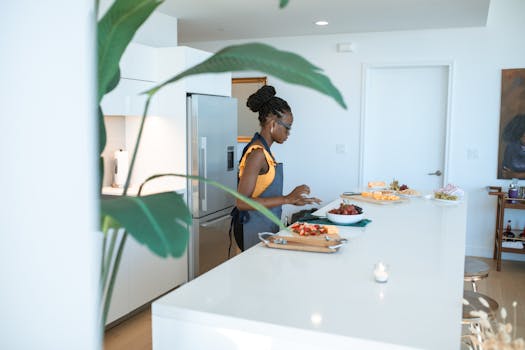 A woman preparing homemade dishes on a kitchen counter, creating a vibrant and modern domestic scene.
