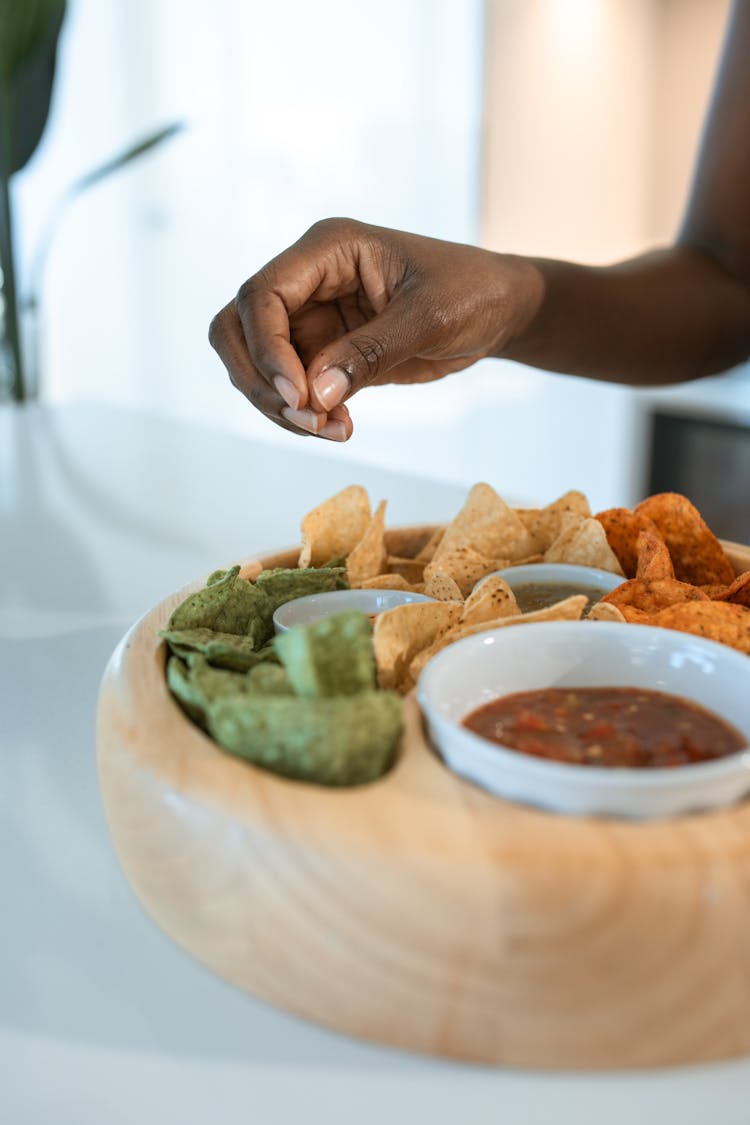 Nachos And Dipping Sauce In A Wooden Bowl