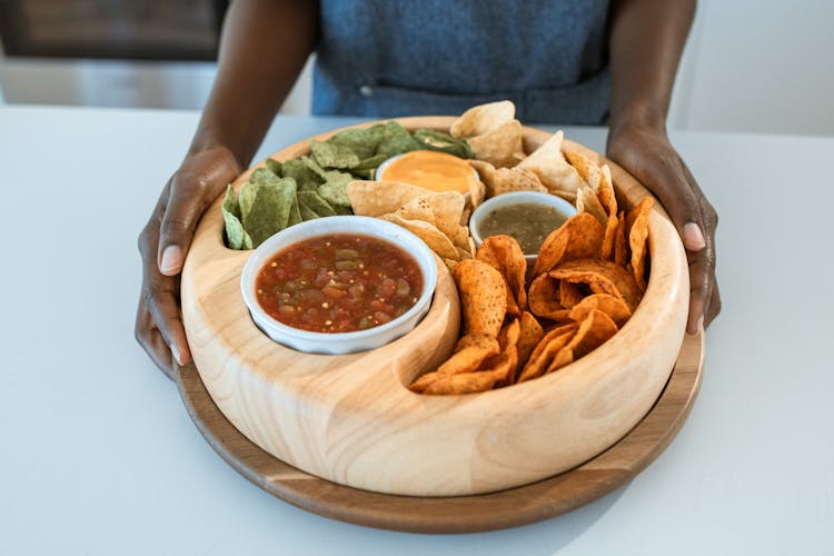 A Person Holding A Food Platter