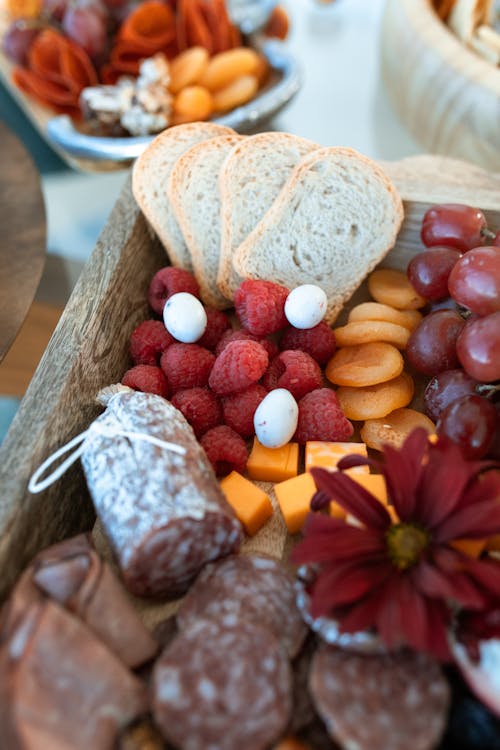 Red and Brown Round Fruits on Brown Wooden Tray