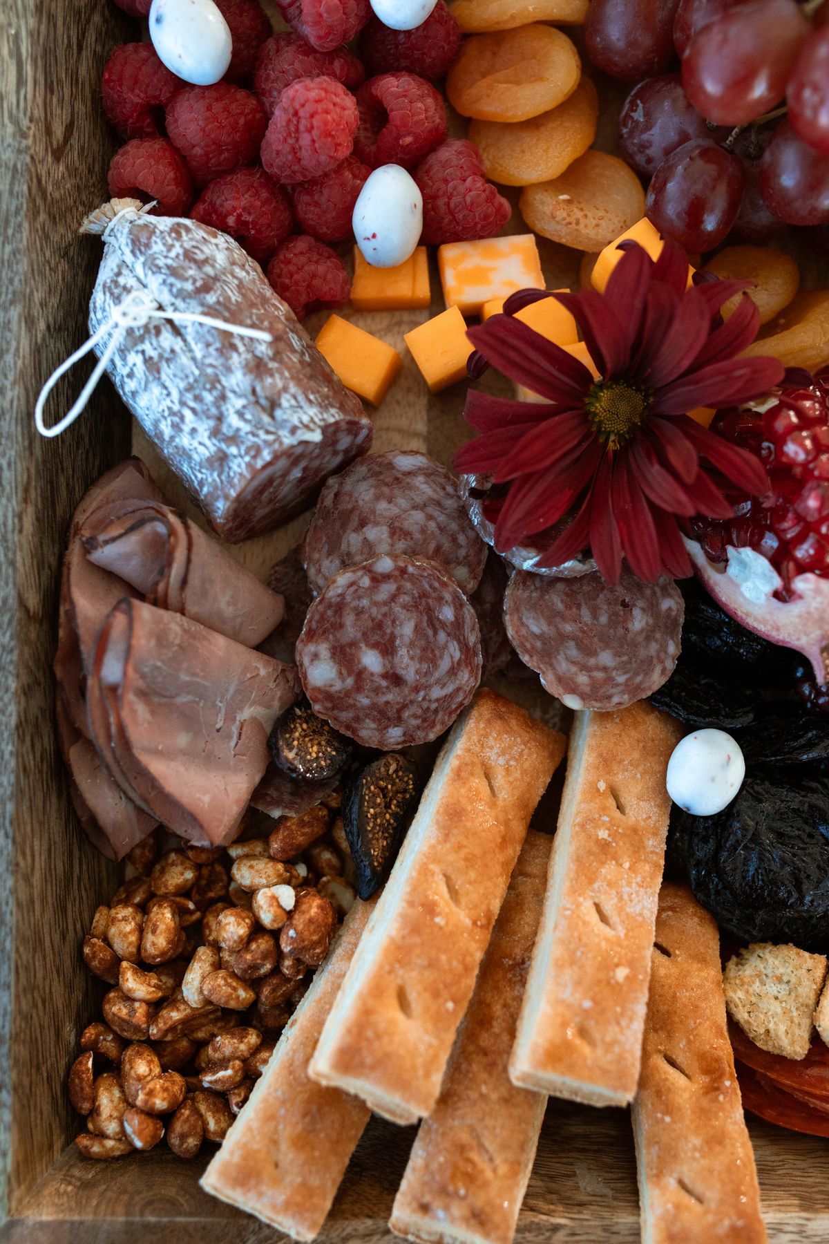 Small rustic cheese board with cured meats and cheese for two to four people