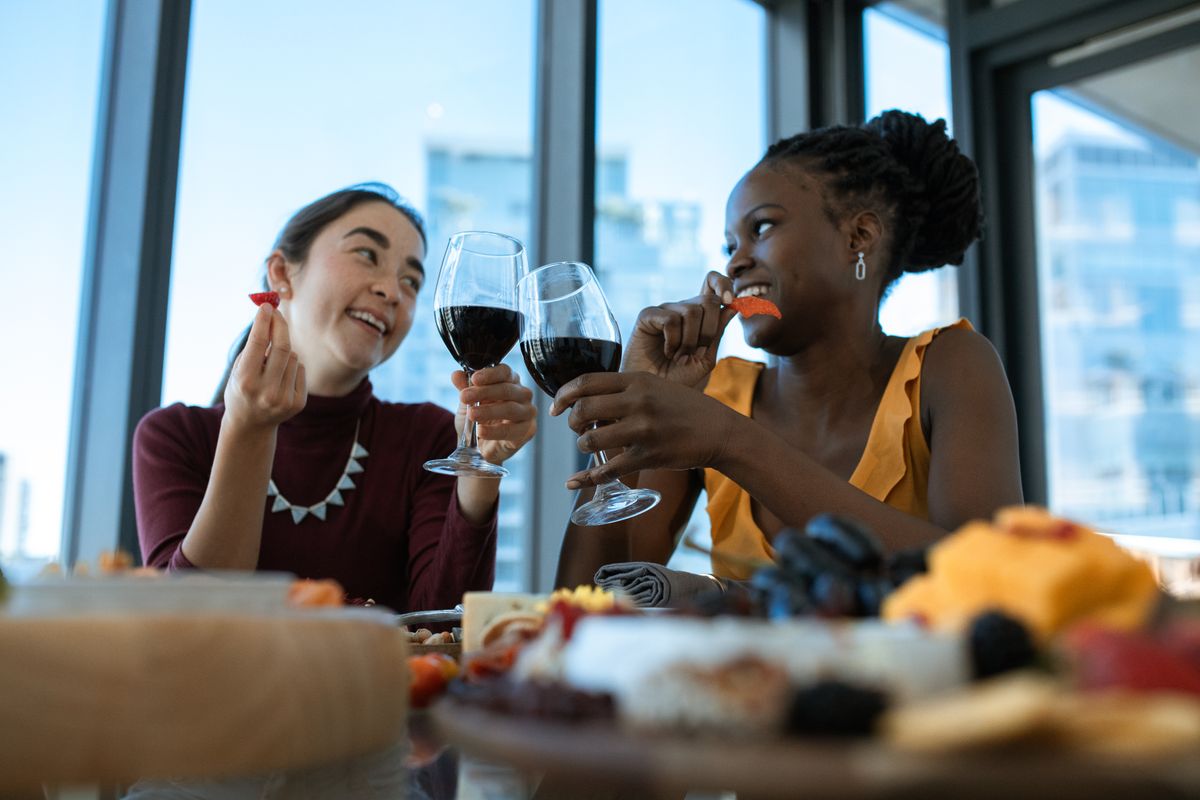 Two women enjoying wine and conversation together at a table
