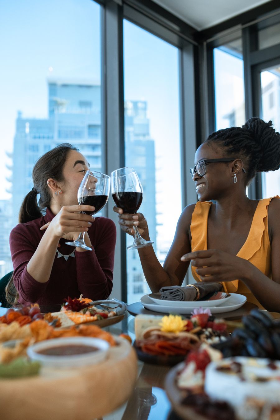 Two friends toasting their wine glasses