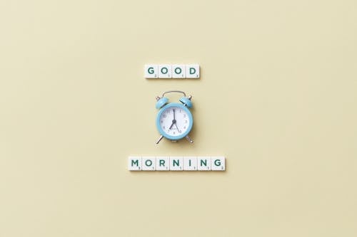 A Phrase Spelled with Scrabble Tiles and an Alarm Clock