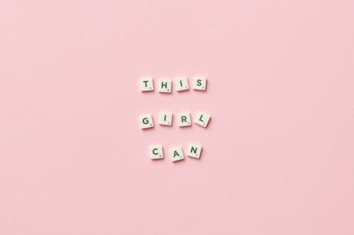 Free Scrabble Pieces on Pink Background Stock Photo