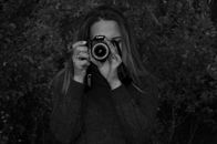Woman in Black Knit Sweater Holding Camera