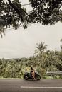 Man in Red Shirt Riding on Black Motorcycle