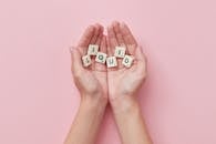 2 White and Red Dice on Persons Hand