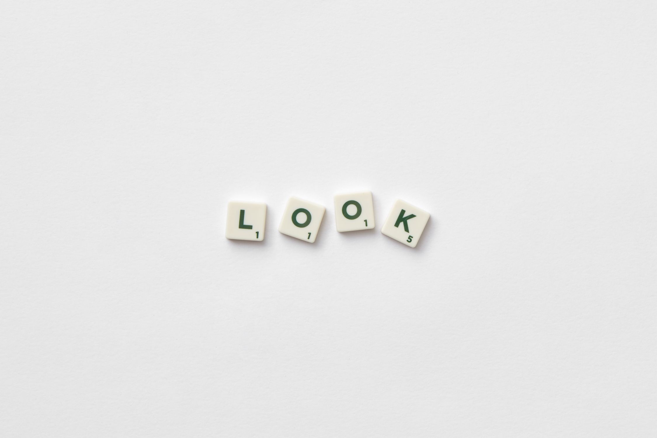 Scrabble tiles spelling words on a white surface