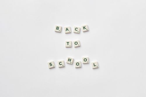 Free Scrabble tiles spelling 'back to school' on a white background. Stock Photo