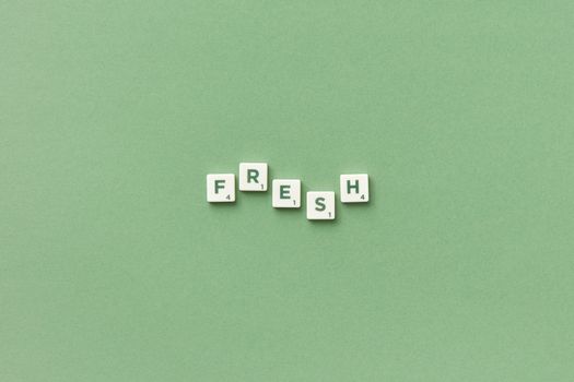 White Scrabble Tiles Combined on Green Background